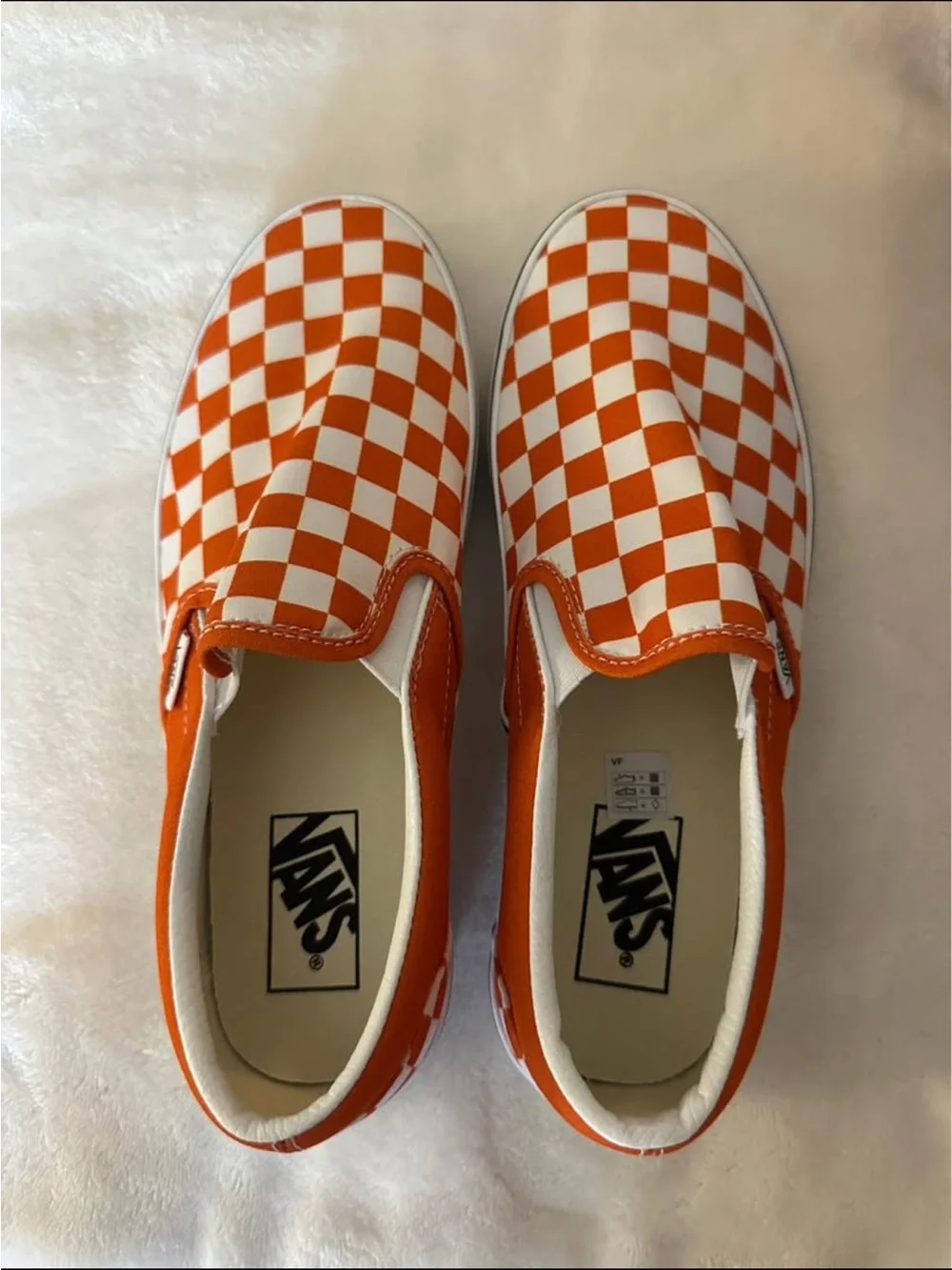 Orange and white checkerboard slip on vans